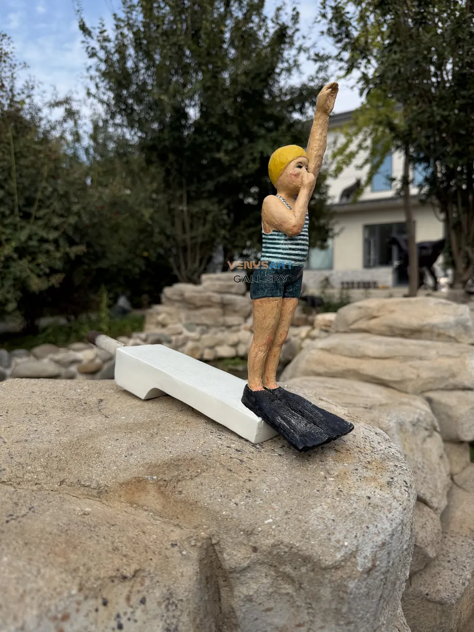 Real product photograph of VT-046 diving child sculpture with white support